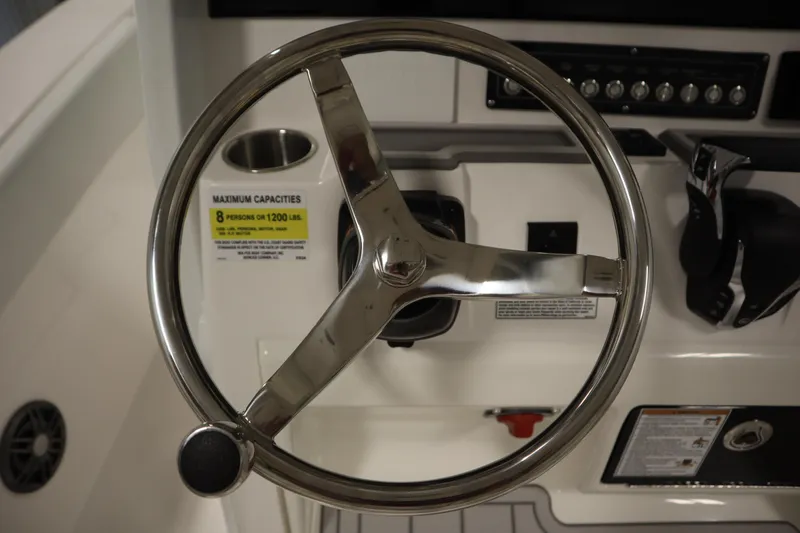 Slide: The Image of Steering wheel of 2026 Sea Fox 228 Commander boat, showcasing control panel and capacity label. - 26