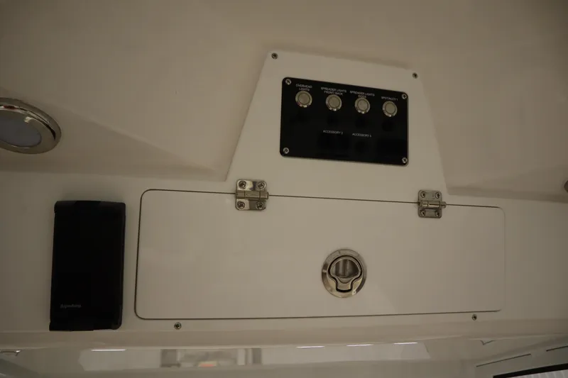 Slide: The Image of 2026 Sea Fox 228 Commander control panel with switches and storage compartment. - 37