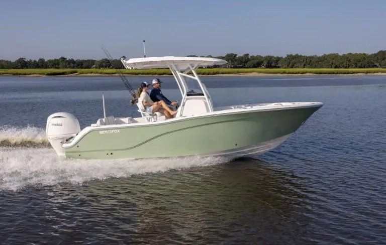 Slide: The Image of 2026 Sea Fox 228 Commander boat cruising on a calm river with two passengers. - 64