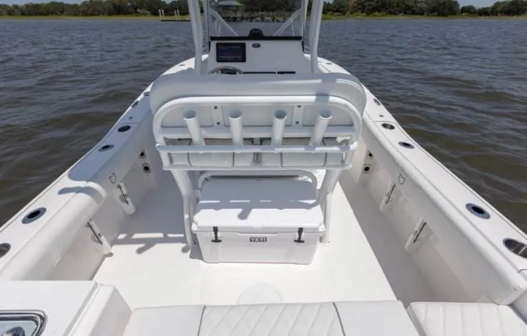 Slide: The Image of 2026 Sea Fox 228 Commander boat interior with seating and rod holders on a calm water body. - 67