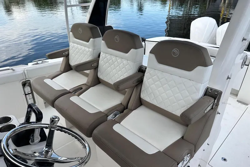 Slide: The Image of 2017 Edgewater 368CC boat with triple outboard engines docked at marina. - 10
