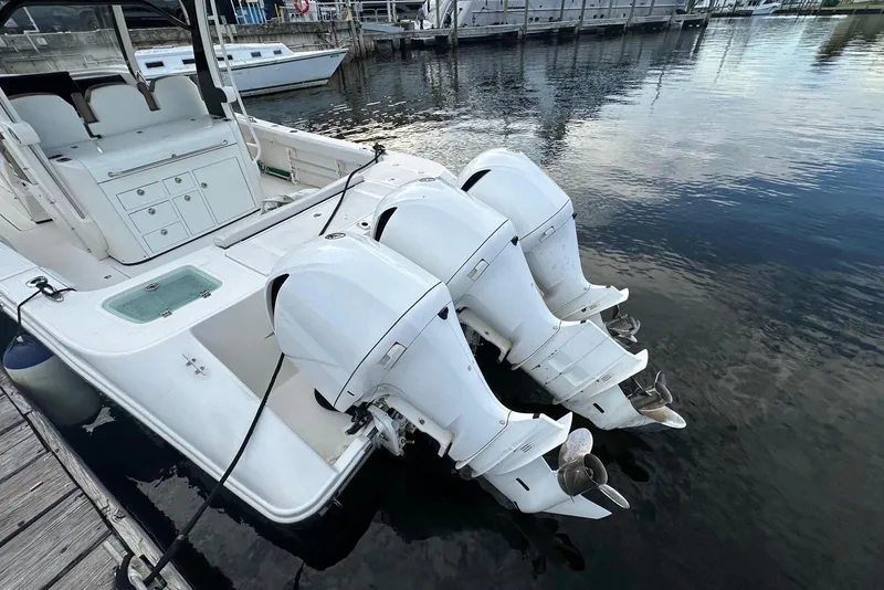 Slide: The Image of 2017 Edgewater 368CC boat docked near a marina with clear skies. - 12