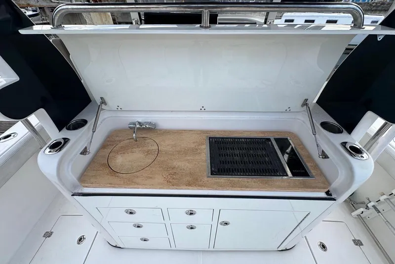 Slide: The Image of 2017 Edgewater 368CC boat helm with steering wheel, navigation screens, and controls. - 13