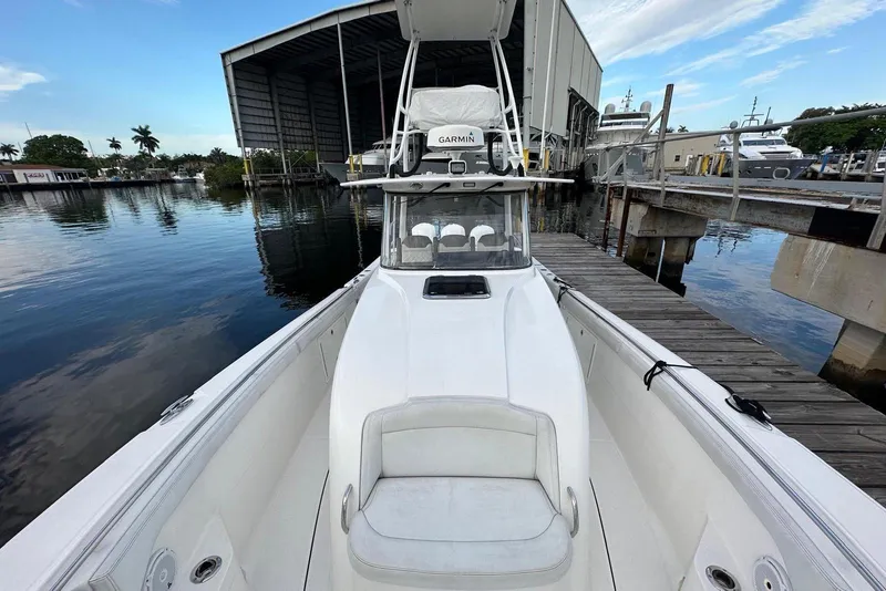 Slide: The Image of 2017 Edgewater 368CC boat docked at marina, showcasing spacious deck and seating area. - 14