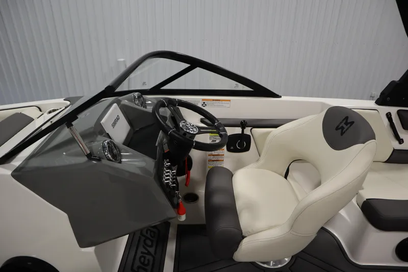 Slide: The Image of 2025 Heyday WT Surf boat interior with steering wheel and captain's seat. - 13