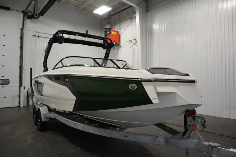 Slide: The Image of 2025 Heyday WT Surf boat in a garage, showcasing sleek design and modern features. - 2