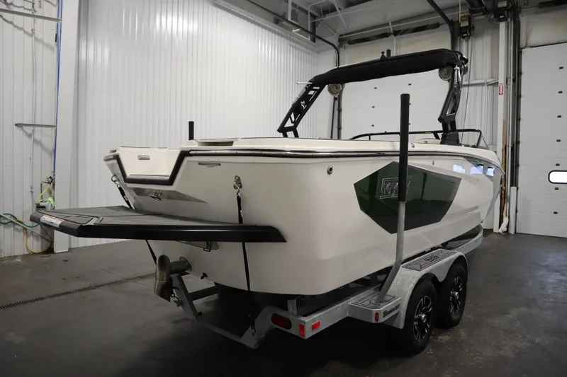 Slide: The Image of 2025 Heyday WT Surf boat on trailer in indoor storage facility. - 4