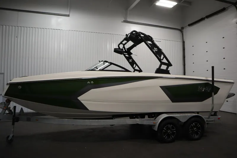 Slide: The Image of 2025 Heyday WT Surf boat on trailer in indoor setting. - 7