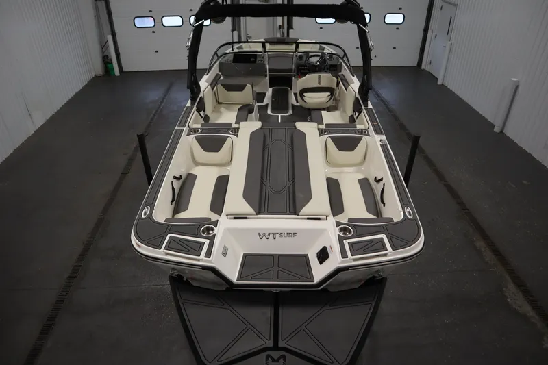 Slide: The Image of 2025 Heyday WT Surf boat interior, featuring spacious seating and modern design in a garage setting. - 9