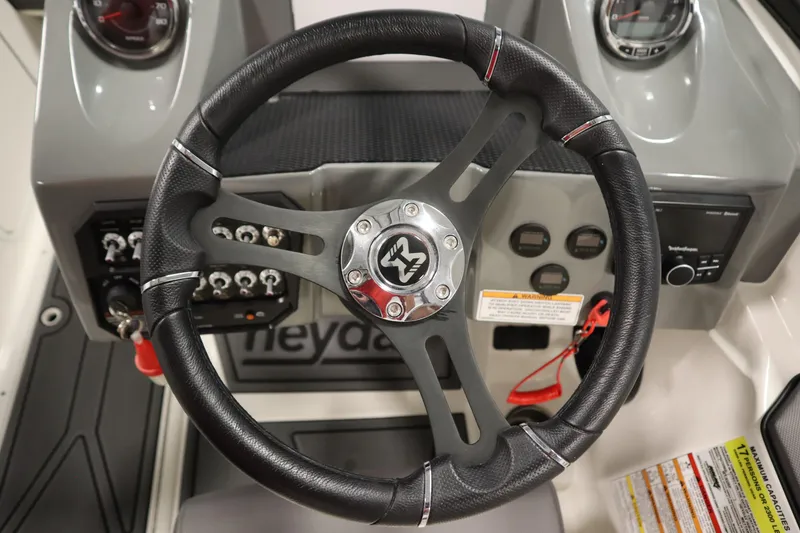 Slide: The Image of Steering wheel and dashboard of 2025 Heyday WT Surf boat, featuring modern controls and gauges. - 15