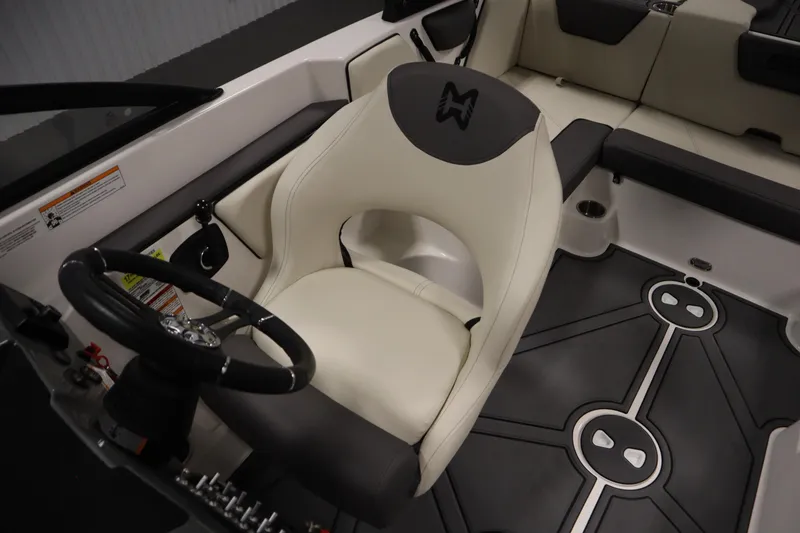 Slide: The Image of 2025 Heyday WT Surf boat interior with steering wheel and cushioned seating. - 23