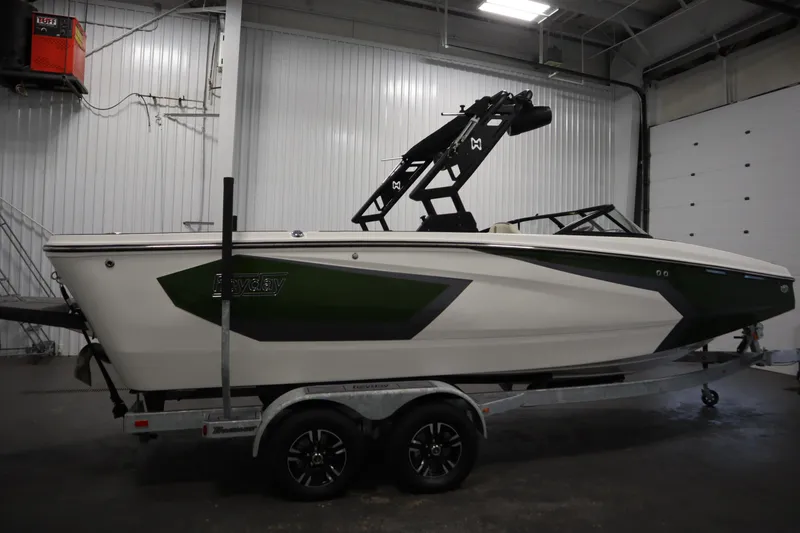 Slide: The Image of 2025 Heyday WT Surf boat on trailer in indoor garage setting. - 3