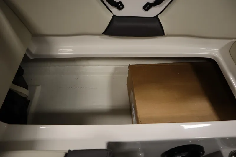 Slide: The Image of Storage compartment in 2025 Heyday WT Surf boat with a cardboard box inside. - 31