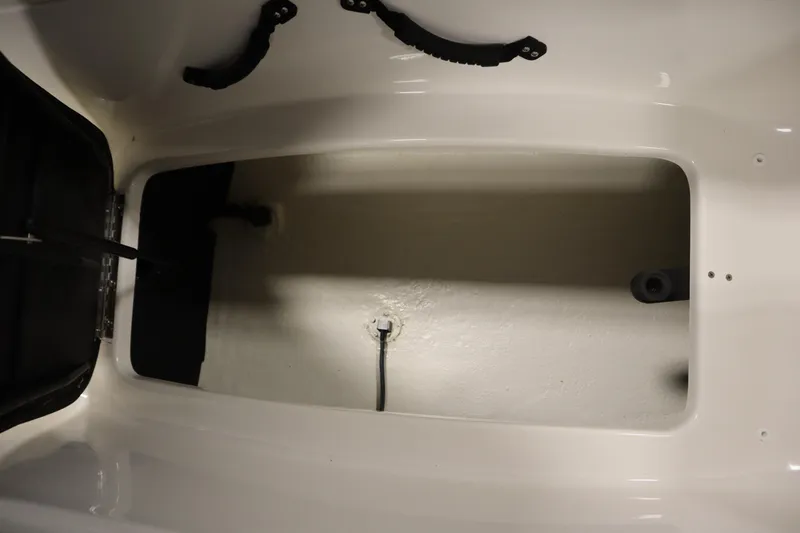 Slide: The Image of 2025 Heyday WT Surf boat storage compartment, white interior, open hatch. - 36
