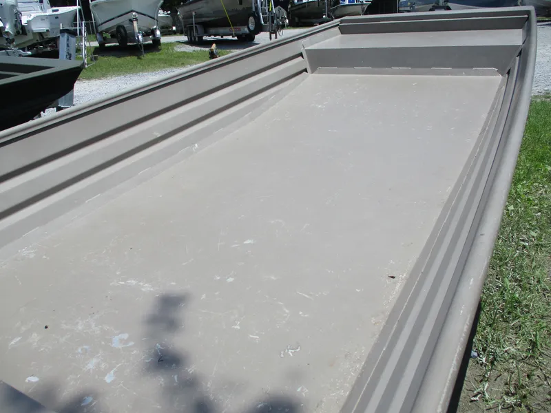 Slide: The Image of 2023 Alweld 1648SS boat hull displayed outdoors on grass. - 3