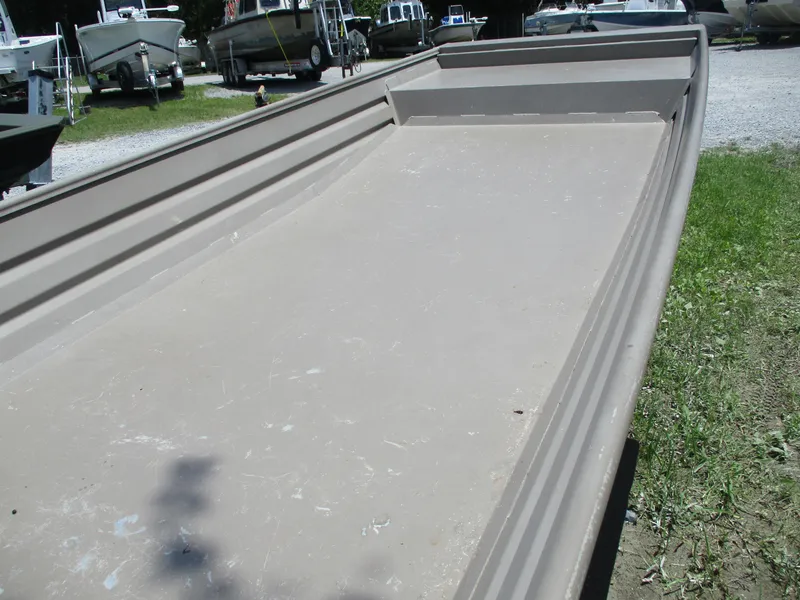 Slide: The Image of 2023 Alweld 1648SS boat on grass, showcasing its spacious interior and sturdy design. - 4