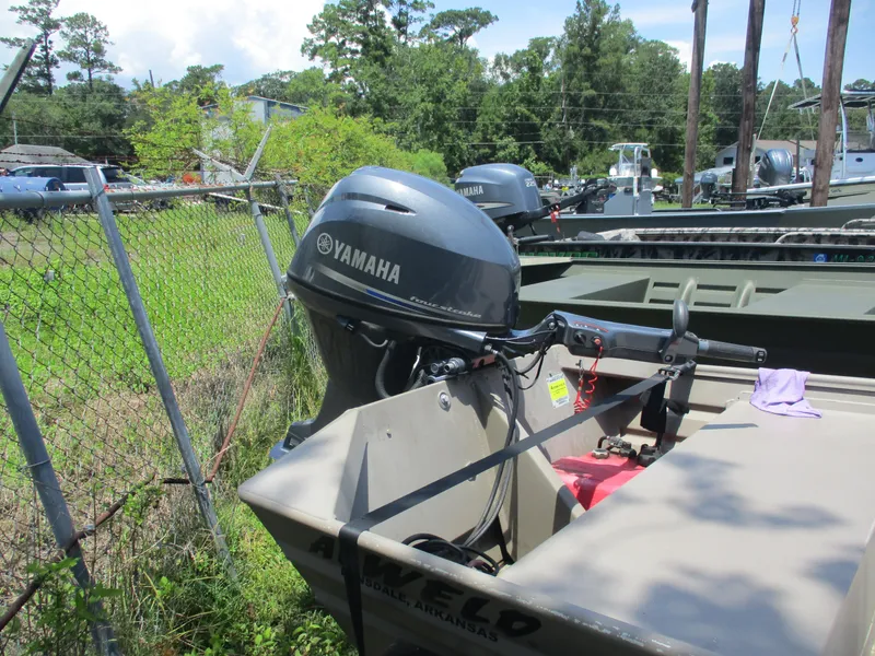 Slide: The Image of 2023 Alweld 1648SS boat with Yamaha outboard motor, parked outdoors near a fence. - 5