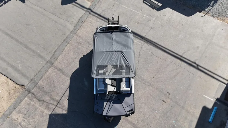 Slide: The Image of Aerial view of 2025 Manitou Cruise boat with canopy on pavement. - 12