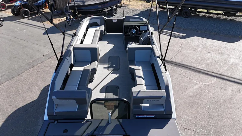 Slide: The Image of 2025 Manitou Cruise pontoon boat with spacious seating and modern design. - 13
