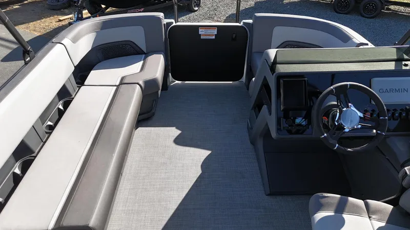 Slide: The Image of 2025 Manitou Cruise boat interior with seating and steering console. - 18