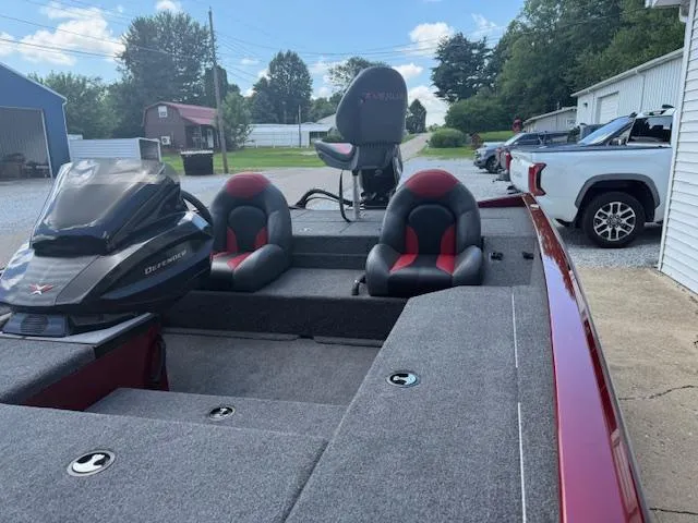Slide: The Image of 2026 Vexus AVX181 boat with red and black seating, parked outdoors on a sunny day. - 8