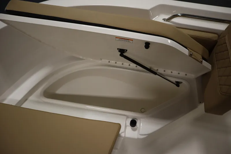 Slide: The Image of 2026 Bayliner 20 Cc Trophy boat storage compartment with cushioned seating. - 12