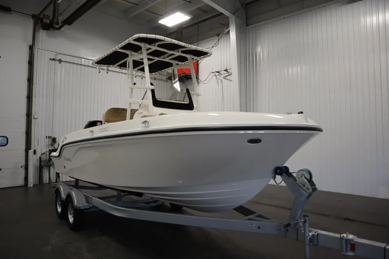 Slide: The Image of 2026 Bayliner 20 Cc Trophy boat on trailer in indoor storage facility. - 2