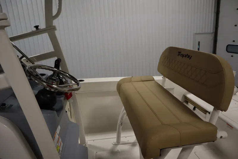 Slide: The Image of 2026 Bayliner 20 Cc Trophy boat interior with steering wheel and tan seating. - 20