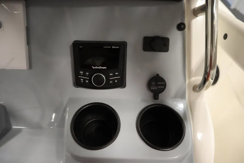 Slide: The Image of 2026 Bayliner 20 Cc Trophy dashboard with stereo system and cup holders. - 24