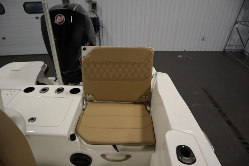Slide: The Image of 2026 Bayliner 20 Cc Trophy boat interior with tan seating and engine view. - 29