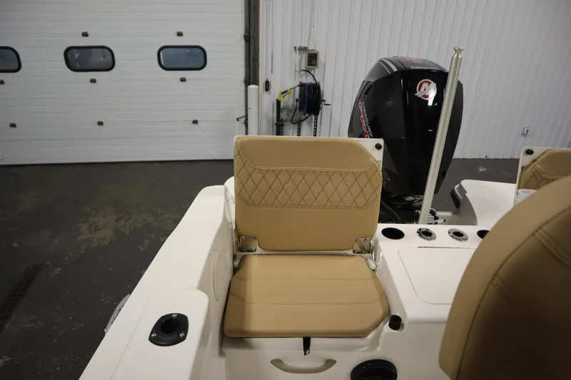 Slide: The Image of 2026 Bayliner 20 Cc Trophy boat interior with tan seating and outboard motor. - 31