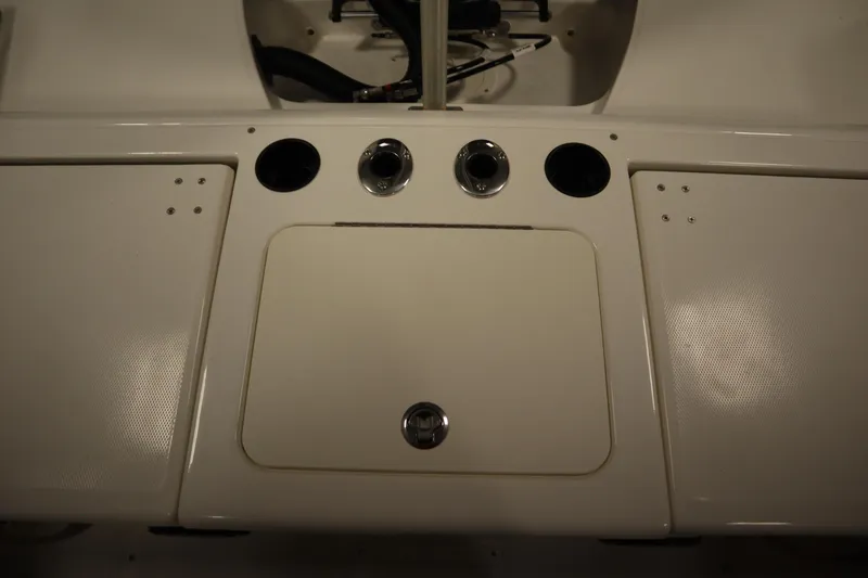 Slide: The Image of 2026 Bayliner 20 Cc Trophy boat dashboard with cup holders and control panel. - 32