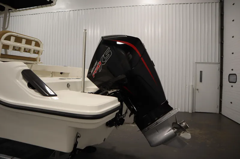 Slide: The Image of 2026 Bayliner 20 Cc Trophy boat with Mercury Pro XS outboard motor in a garage. - 36