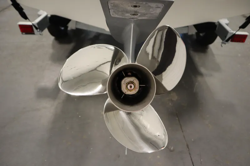Slide: The Image of 2026 Bayliner 20 Cc Trophy boat propeller, close-up view in a garage setting. - 38