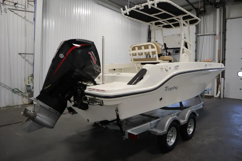 Slide: The Image of 2026 Bayliner 20 Cc Trophy boat on trailer in indoor storage. - 4