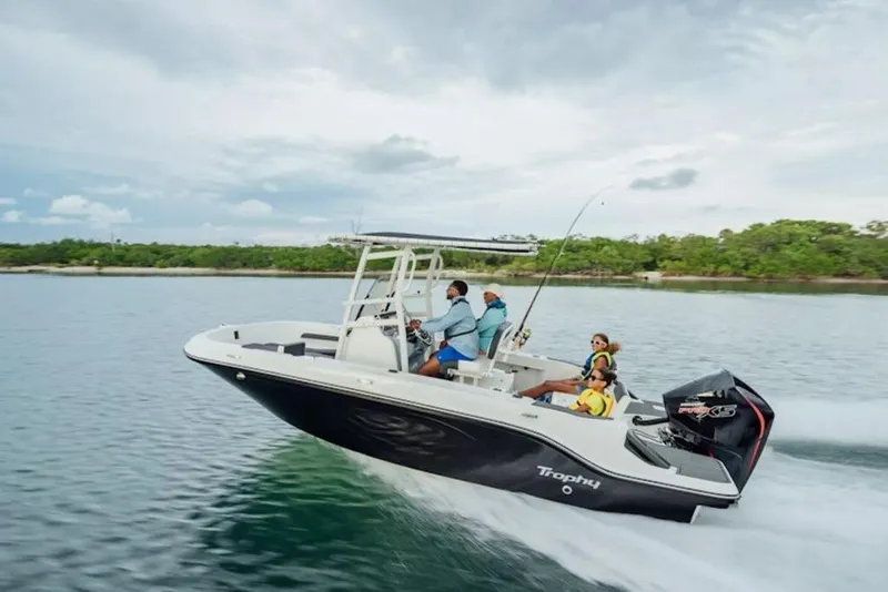 Slide: The Image of 2026 Bayliner Trophy T20CC boat cruising on a scenic waterway with passengers. - 43