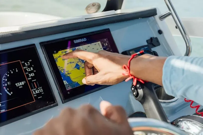 Slide: The Image of Person navigating with touchscreen on 2026 Bayliner Trophy T20CC boat. - 46