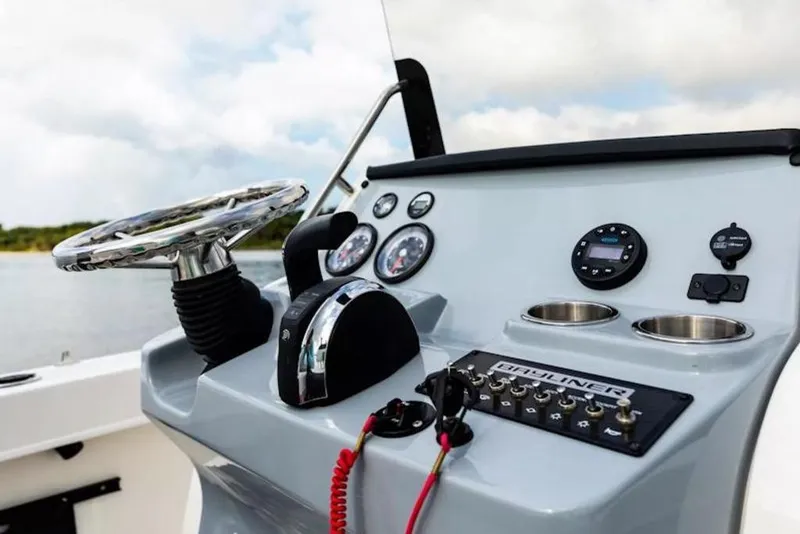 Slide: The Image of 2026 Bayliner Trophy T20CC boat dashboard with steering wheel and control panel. - 47