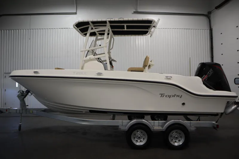 Slide: The Image of 2026 Bayliner 20 CC Trophy boat on trailer in indoor setting. - 7