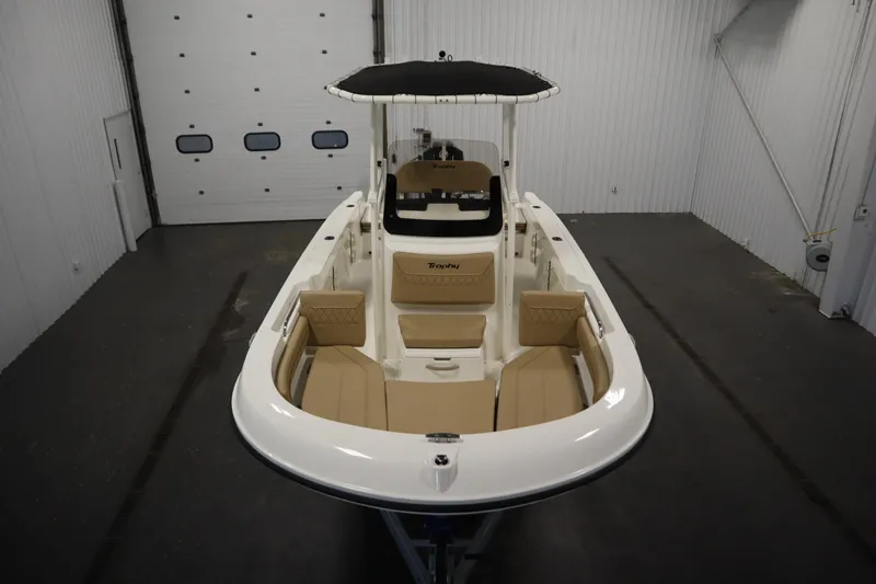 Slide: The Image of 2026 Bayliner 20 Cc Trophy boat in a spacious indoor storage facility. - 8
