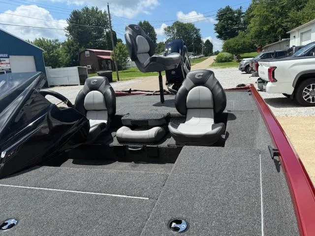 Slide: The Image of 2026 Crestliner XF179 boat interior with three seats, parked outdoors on a sunny day. - 8