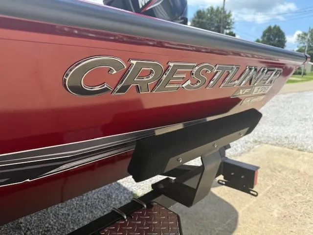 Slide: The Image of 2026 Crestliner XF179 boat, red exterior, close-up of logo and trailer. - 9