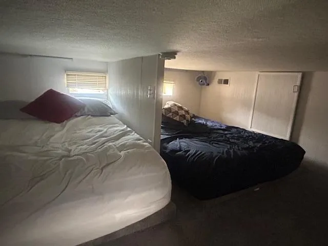 Slide: The Image of 1999 Skipperliner houseboat interior with cozy sleeping area and two beds. - 10