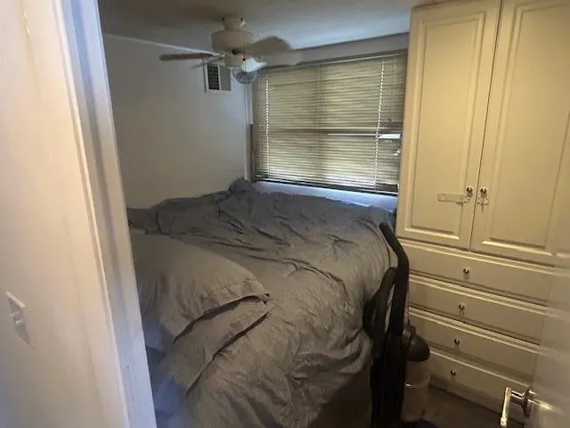 Slide: The Image of Cozy bedroom in 1999 Skipperliner 59 x 14 houseboat with bed, cabinets, and window blinds. - 14