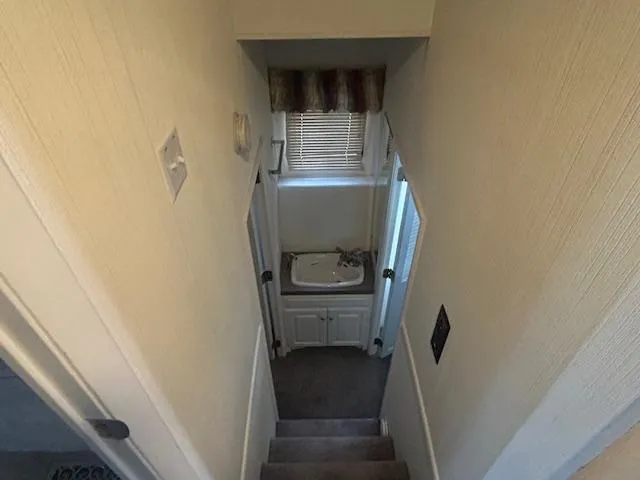 Slide: The Image of Narrow stairway leading to a small bathroom in a 1999 Skipperliner houseboat. - 15