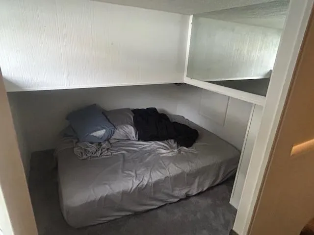 Slide: The Image of Cozy bedroom in a 1999 Skipperliner 59 x 14 houseboat with a neatly made bed. - 17
