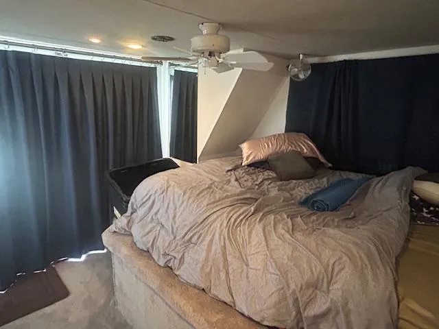 Slide: The Image of Cozy bedroom in 1999 Skipperliner 59 x 14 houseboat with curtains and ceiling fan. - 18