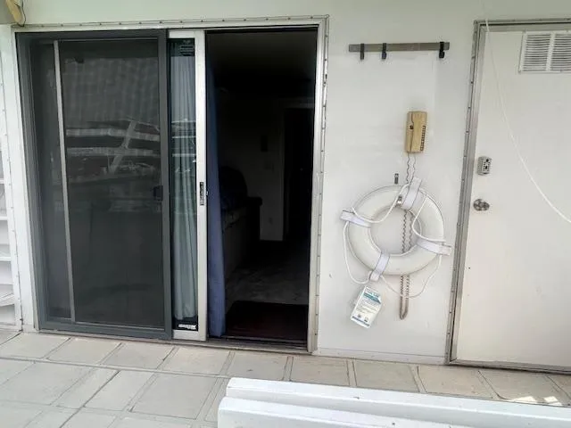 Slide: The Image of 1999 Skipperliner 59 x 14 houseboat with sliding door, life preserver, and outdoor phone. - 22