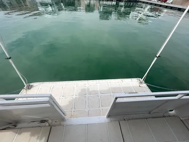 Slide: The Image of 1999 Skipperliner 59 x 14 Houseboat deck overlooking calm water. - 23