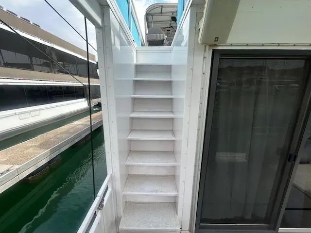 Slide: The Image of Staircase on a 1999 Skipperliner 59 x 14 houseboat, leading to the upper deck. - 27